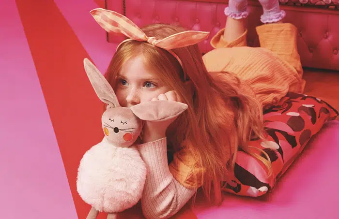 Girl laying down with toy